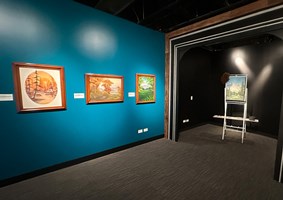 View of several original Boss Ross paintings at the Dunn Museum