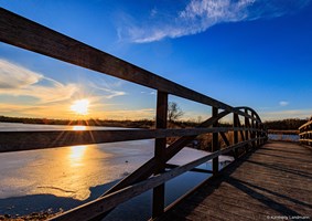 Beautiful winter solstice sunset reflecting off the frozen lake