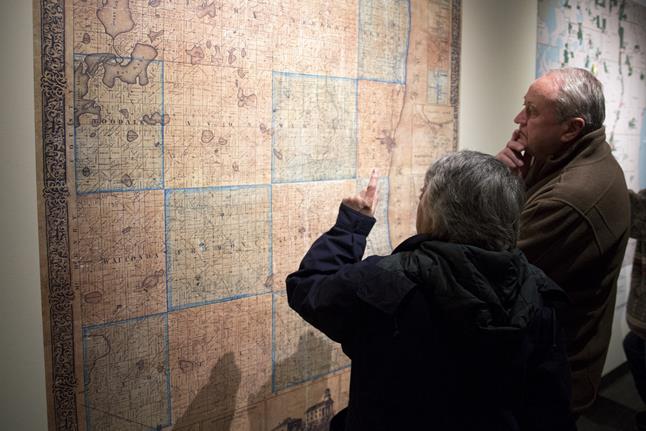 Seniors viewing an old map at the Dunn Museum