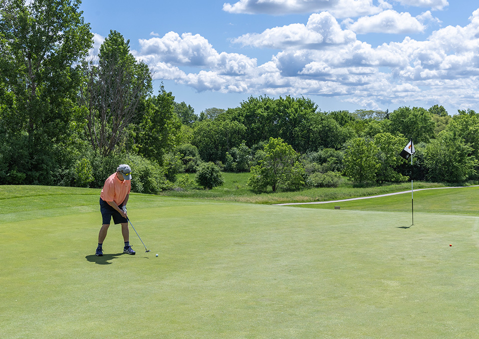 Golfer teeing off at Countryside Golf Course.