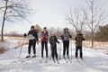 Five cross country skiers standing together for a group photograph