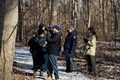 Volunteer photographers walking through the woods taking photos.