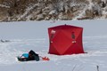 Red ice shanty in the middle of the lake