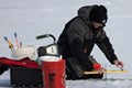 Man setting up his ice fishing pole