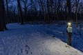 Photo of the snow covered solar-lit trails at night time