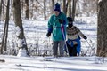 A couple cross-country skiing through the woods