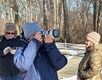 Volunteer photographers walking through the woods taking photos.