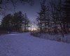 Sun setting over solar-lit trails