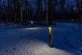 Snow covered solar-lit trails at night time