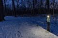 Snow covered solar-lit trails at night time