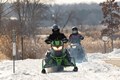 Photo of two snowmobiles riding the trails