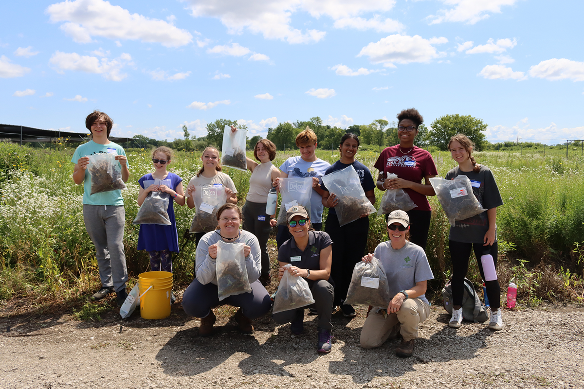 Natural Resource instructor working with kids in the field