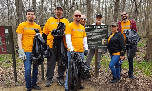 Group of volunteers helping clean up a Habitat Restoration area.