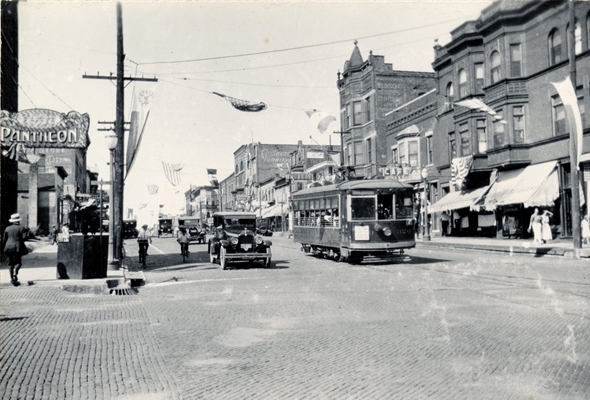 Street trolley, old cars and scooters driving down city streets